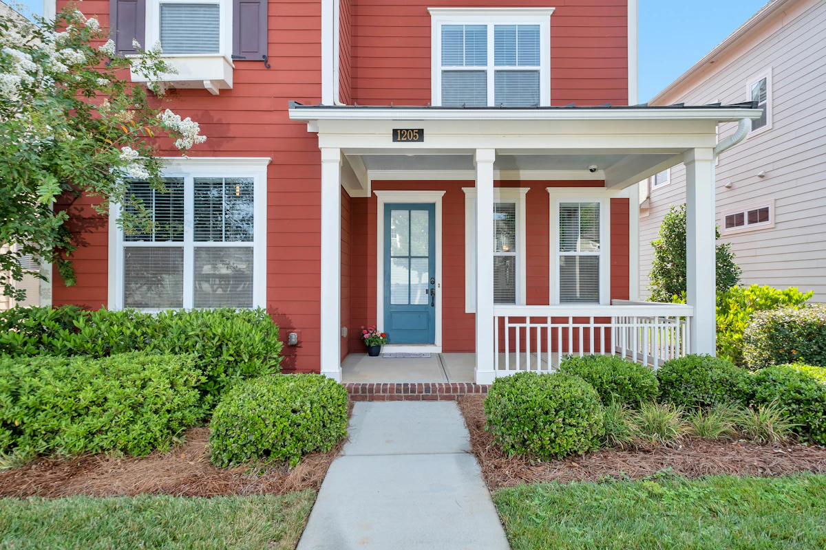 Red suburban house with a covered front porch